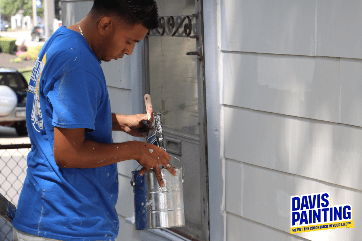 Davis Painting crew member painting with an oil-based paint