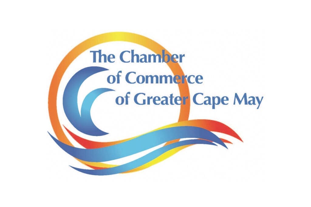 Logo for The Chamber of Commerce of Greater Cape May featuring stylized blue waves and an orange-yellow sun in the background, with the organization’s name written in blue text.