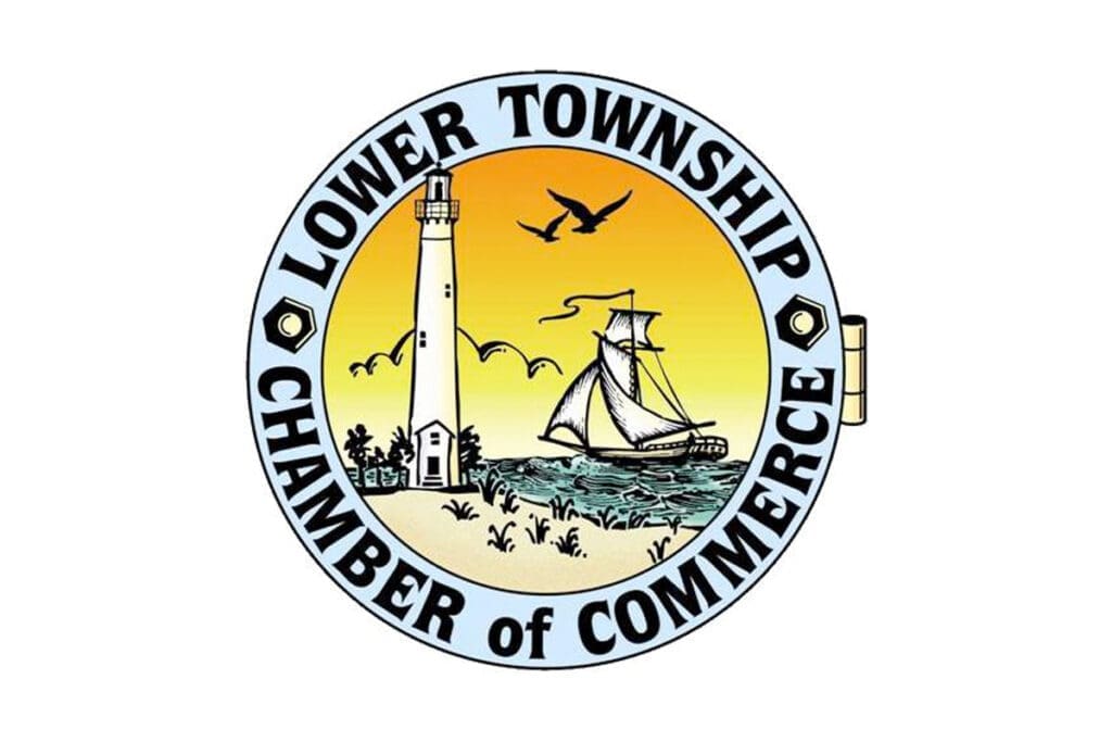 A circular logo for the Lower Township Chamber of Commerce featuring a lighthouse, a sailing ship on the water, seagulls in the sky, and a sunset-colored background.